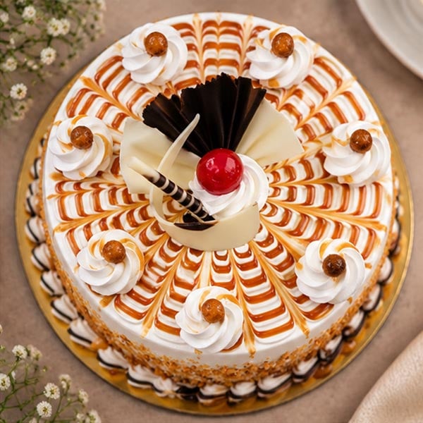 Delightful Caramel Butterscotch Cake with Cream & Chocolate Garnish 2